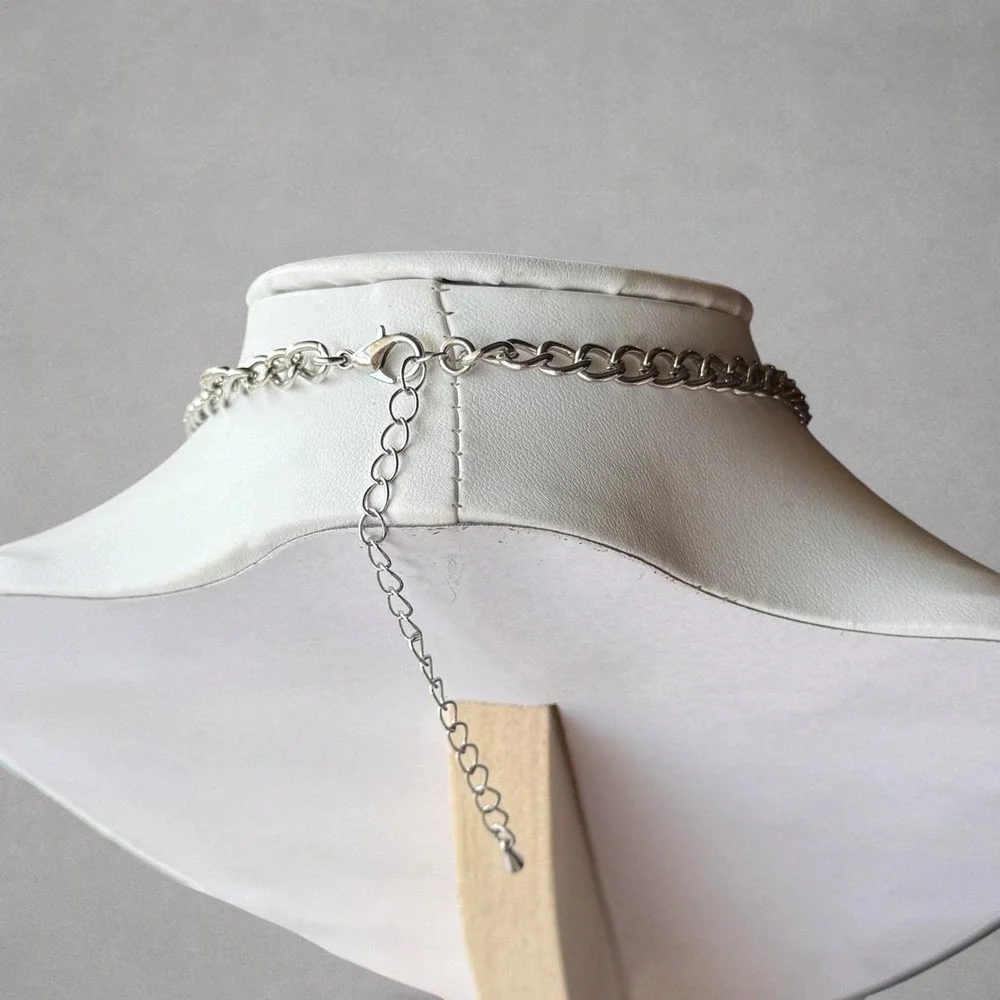 Silver-tone butterfly pendant necklace featuring an ornate butterfly charm .